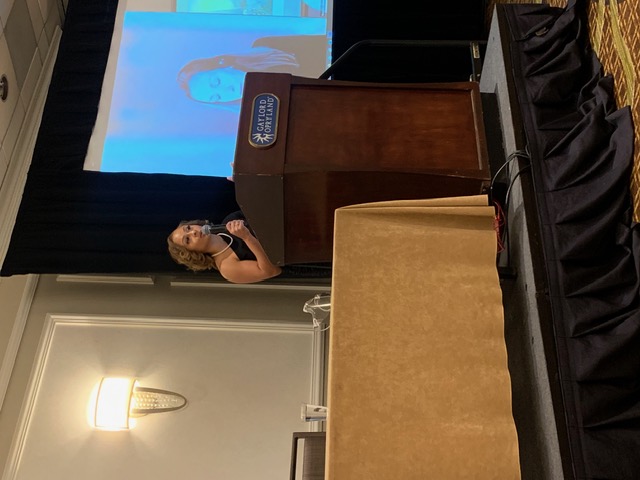 Jasmine R. Johnson on stage at a podium, Gaylord Opryland